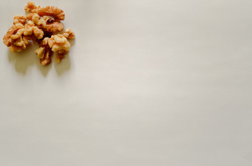 Group of peeled walnuts on the top left on white background. Healthy Food For The Heart.