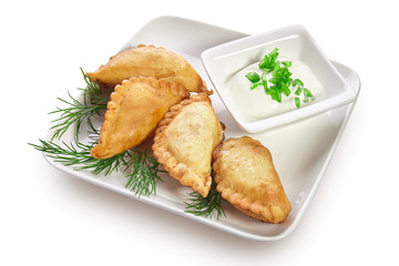 Chebureks on a white plate isolated on a white background