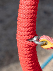 Red twisted rope in net for climbing and playing