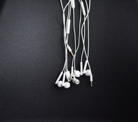 smartphone headphones are white on a black background