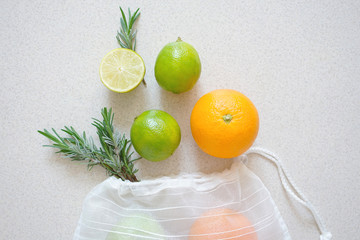 
fabric bag for storing foods with different citrus and sprigs of rosemary. Zero waste concept