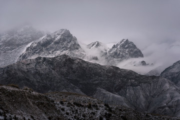 Fototapeta na wymiar View of snow mountain surrounded by clouds with morning fog