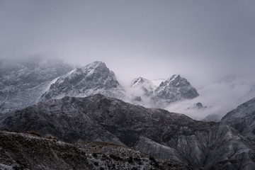 View of snow mountain surrounded by clouds with morning fog