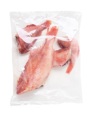 Frozen fish sea bass in plastic net bag isolated