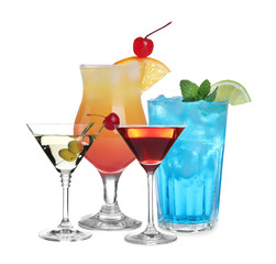 Set of refreshing alcoholic drinks on white background
