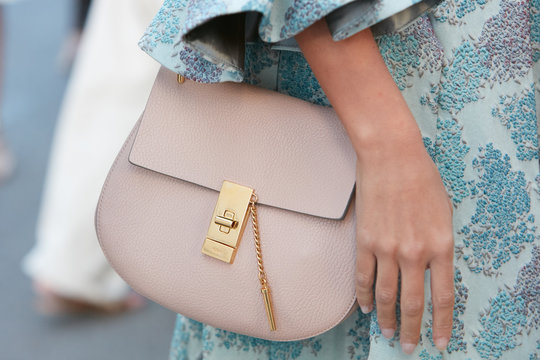 Woman with pink leather Chloe bag and blue floral dress on September 21, 2017 in Milan, Italy