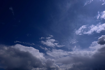 Naklejka na ściany i meble Lush mesmerizing clouds in a blue sky on a bright Sunny day