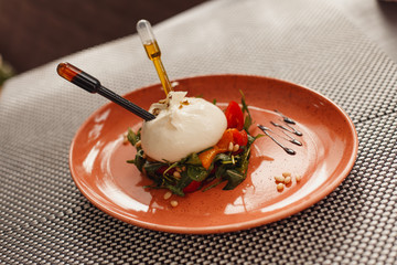 caprese salad with mozzarella inserted pipettes with olive oil and balsamic