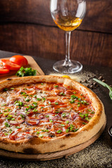 Italian Cuisine. Thin pizza with bacon, red onion, green onion and mushrooms in tomato sauce. Background image. copy space