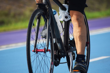 Naklejka premium sporty cyclist rides a bicycle on the road against the backdrop hobbies and sports