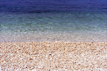 Beautiful pebble beach on a sunny day on the Adriatic Sea.
