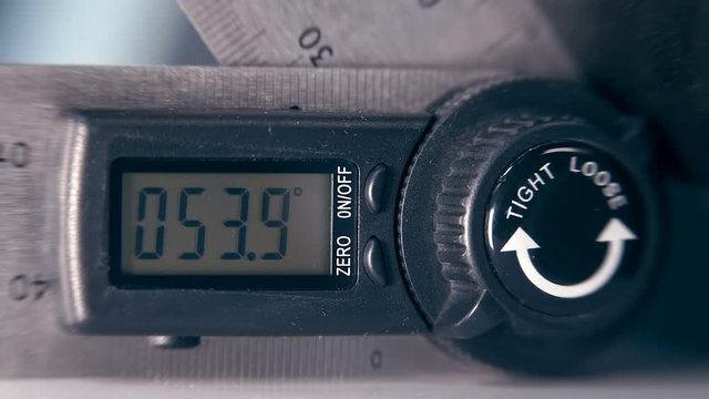 The modern device, which is very necessary in construction and repair - digital goniometer - measuring the angle of an inclined surface. Macro. Closeup