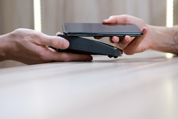 Hand and mobile payment in coffee shop ,mobile payment concept