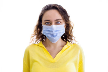Woman wearing face mask at home. Covid-19 virus protection.
