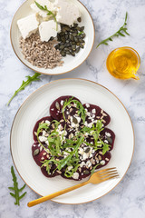 Beetroot carpaccio with feta cheese, rucola leaves, sunflower and pumpkin seeds.