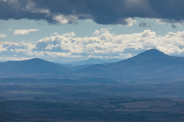 Fototapeta na wymiar Landscape of mountains with clouds in the Moncayo area and the Iberian mountain system, looking towards Cabezo de Los Frailes in the Tabuenca area, Talamantes, near Borja, Zaragoza province.