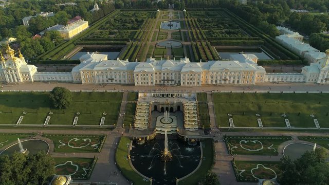 Aerial epic climb best of Russia famous imperial suburban palace St. Petersburg. Simmetrical cascade fountains. Unique park garden territory. Travel tourist best landmark peterhof. Sunset