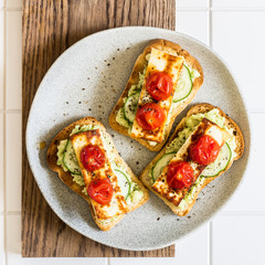 Avocado, Fried Cheese, Cucumber and Tomato Toasts