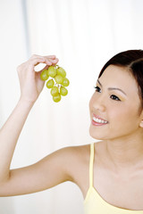Obraz na płótnie Canvas Woman about to eat grapes