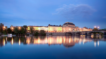 Fototapeta na wymiar Evening cityscape about Prague Czech republic.The National theatre and Legion bridge is on the picture. Splendid reflectiion in Moldva river