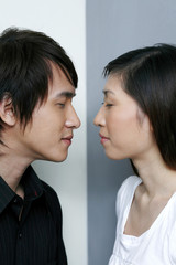 Man and woman closing eyes, about to kiss