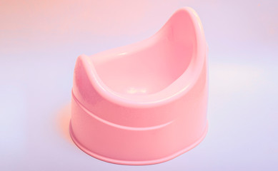 Toilet training chamber pot for small children. Potty pink on a white background.