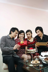 Woman getting birthday presents from her friends