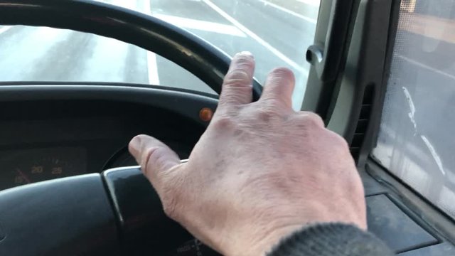 Hand on the wheel of a truck