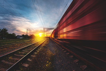 freight, passenger train moves with speed by rail