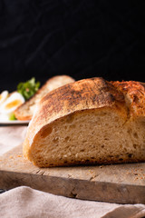 Healthy meal food concept homemade organic artisan sourdough bread and boiled egg in white plate with copy space