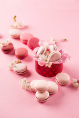 Pink macaroons in red gift box