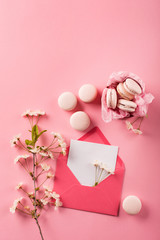 Roze macaroons in gift box and Cherry blossoms © Iuliia Metkalova