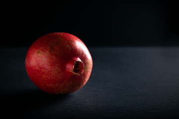 Fototapeta na wymiar Pomegranate on dark background