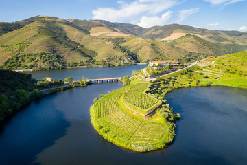 Douro wine valley region drone aerial view of s shape bend river in Quinta do Tedo at sunset, in...