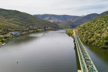 Fototapeta na wymiar Douro railway bridge drone aerial view of river wine region in Ferradosa, Portugal