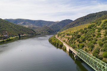 Douro railway bridge drone aerial view of river wine region in Ferradosa, Portugal