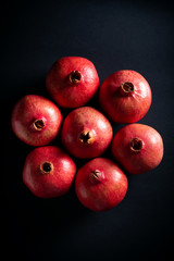 Fototapeta na wymiar Group of pomegranate on dark background
