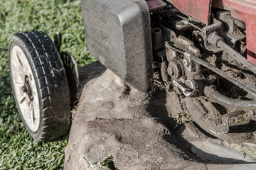 Heavy grimed up and dirty petrol mower engine, prior to its annual service. Fibre glass has been...