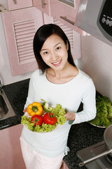 Woman holding a plate of vegetables