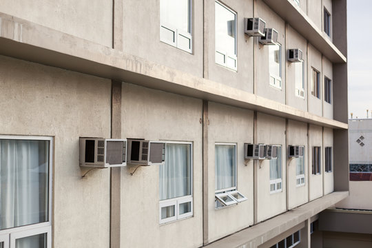 Exterior of building with windows and air conditions on wall