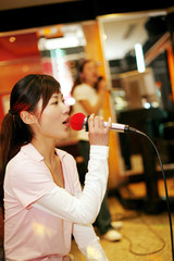 Woman singing into microphone