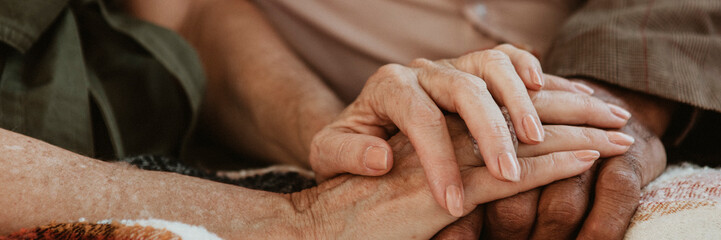 Senior couple holding hands together