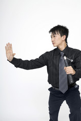 Businessman with nunchaku striking a pose for the camera