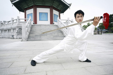 Man practising martial arts with a sword