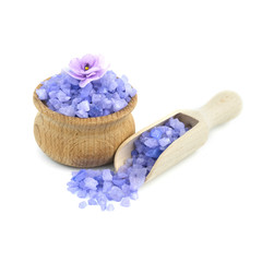 Obraz na płótnie Canvas Sea salt in wood bowl with wood scoop, violet flowers on the top, isolated on white background...