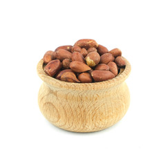 Peanuts in wood bowl close up isolated on white background..