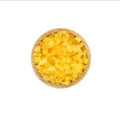 Yellow sea spa salt in wood bowl isolated on white background.