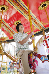 Man riding on carousel