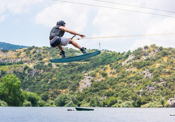 man doing water-skiing in nature. © javier