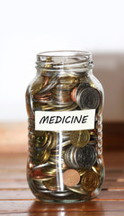 A jar full of coins with medicine label concept for savings for hospital bills